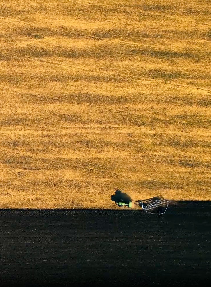 Shadow of Climate Impulse over the farming fields, aerial view